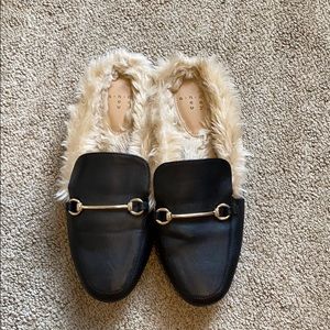 Black faux leather loafers with faux fur lining